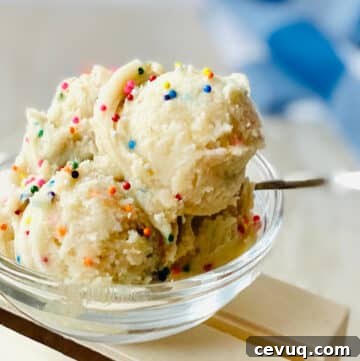 edible sugar cookie dough recipe in bowl with sprinkles and a spoon.