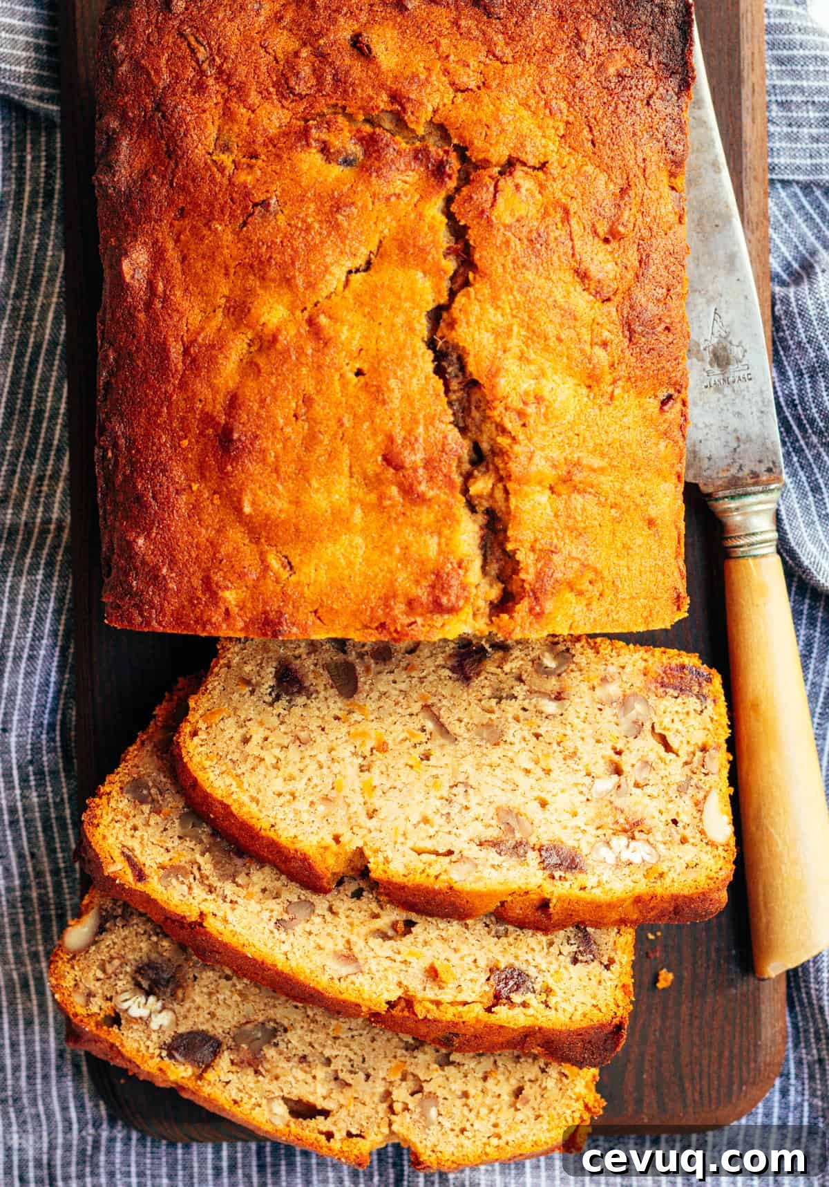 Sweet Potato Bread loaf and three slices on a cutting board with a knife.
