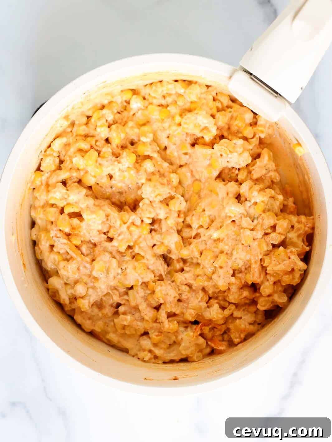 Cheesy corn casserole mixture in a medium saucepan.