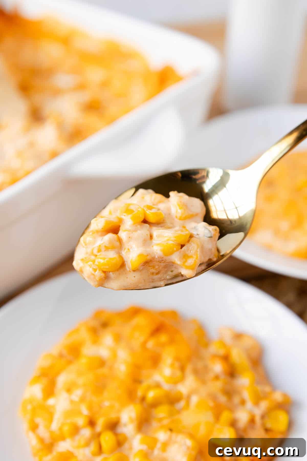 Spoonful of cheesy Velveeta corn casserole.