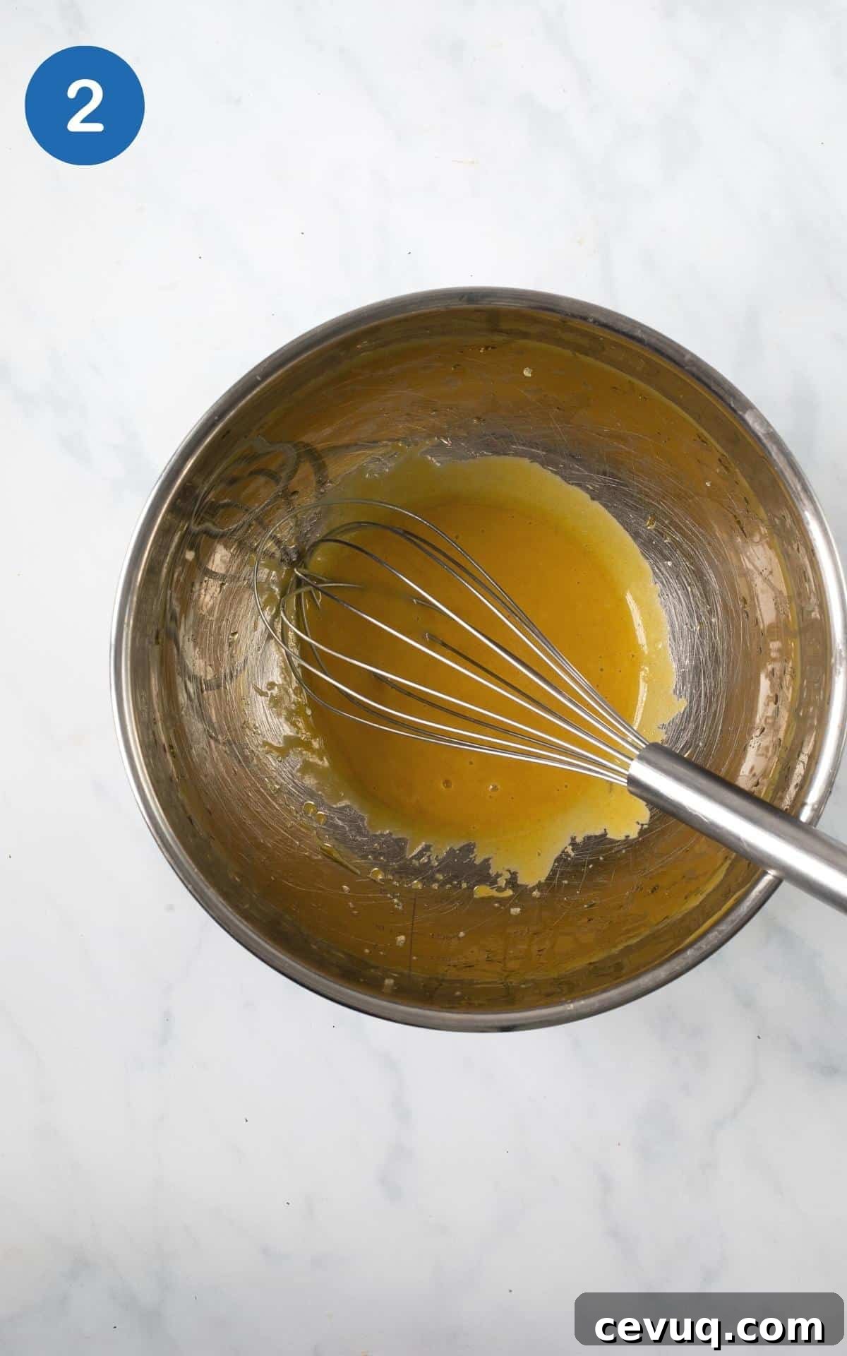 Crispy Roasted Parsnips with Honey and Thyme 5 mustard, maple, olive oil, salt mixed in a silver mixing bowl with a whisk.
