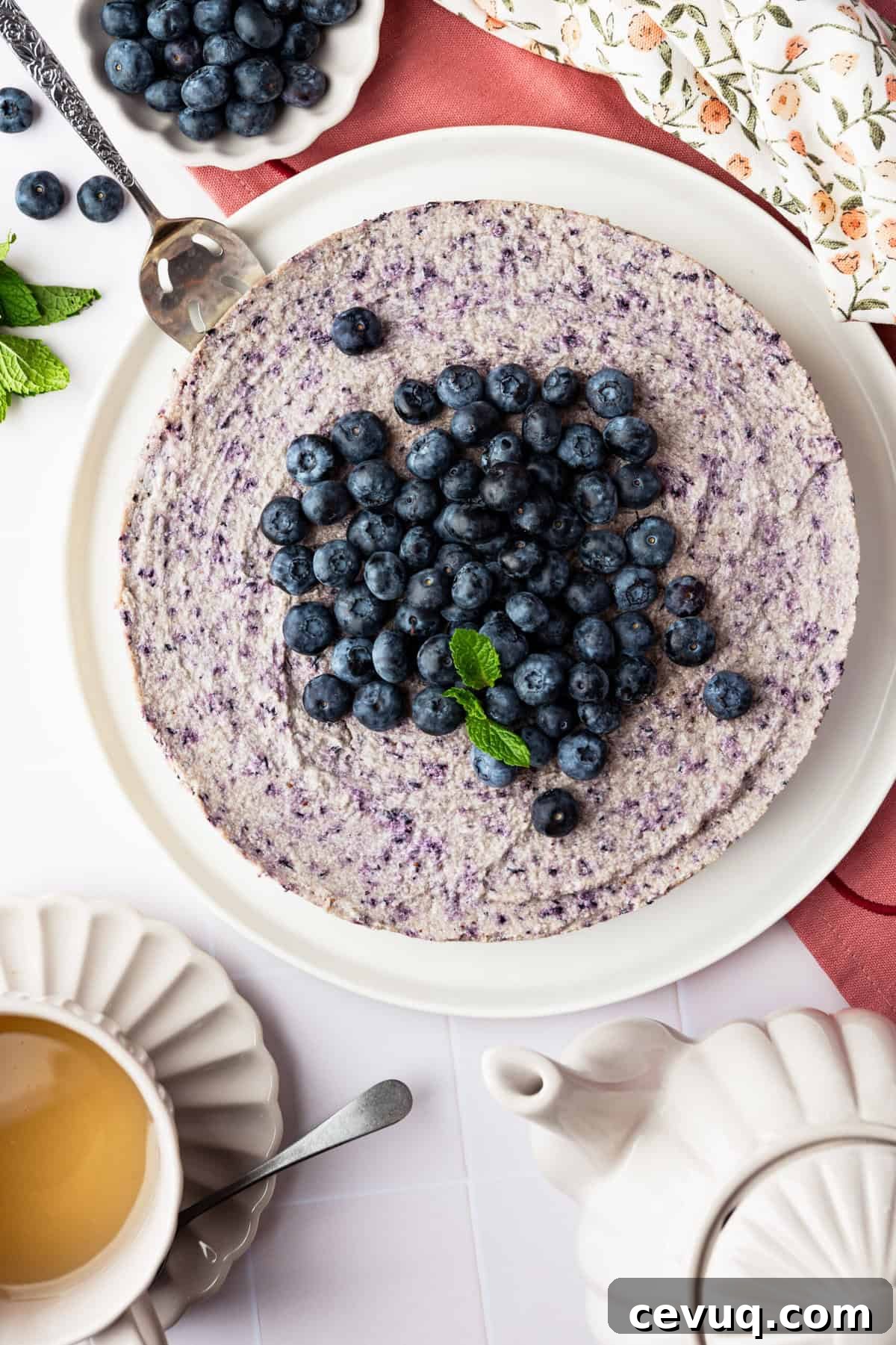A blueberry cheesecake topped with fresh blueberries.