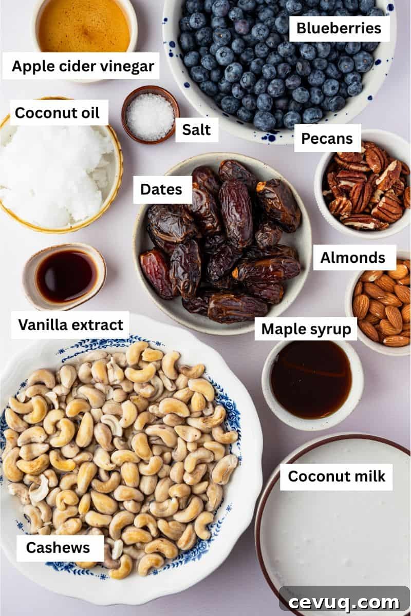 Ingredients for making vegan blueberry cheesecake separated into bowls including cashews, blueberries, dates, pecans and maple syrup.