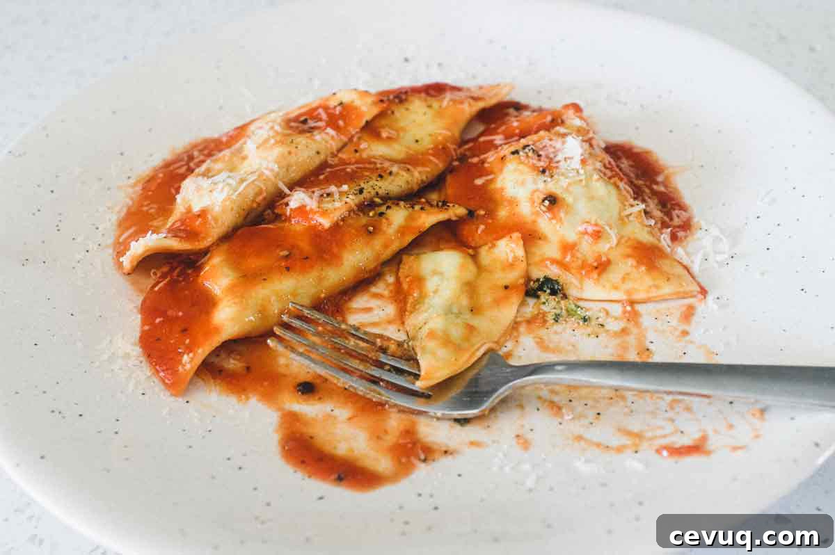 A bowl Mezzelune Pasta with Cavolo Nero & Ricotta with a fork.