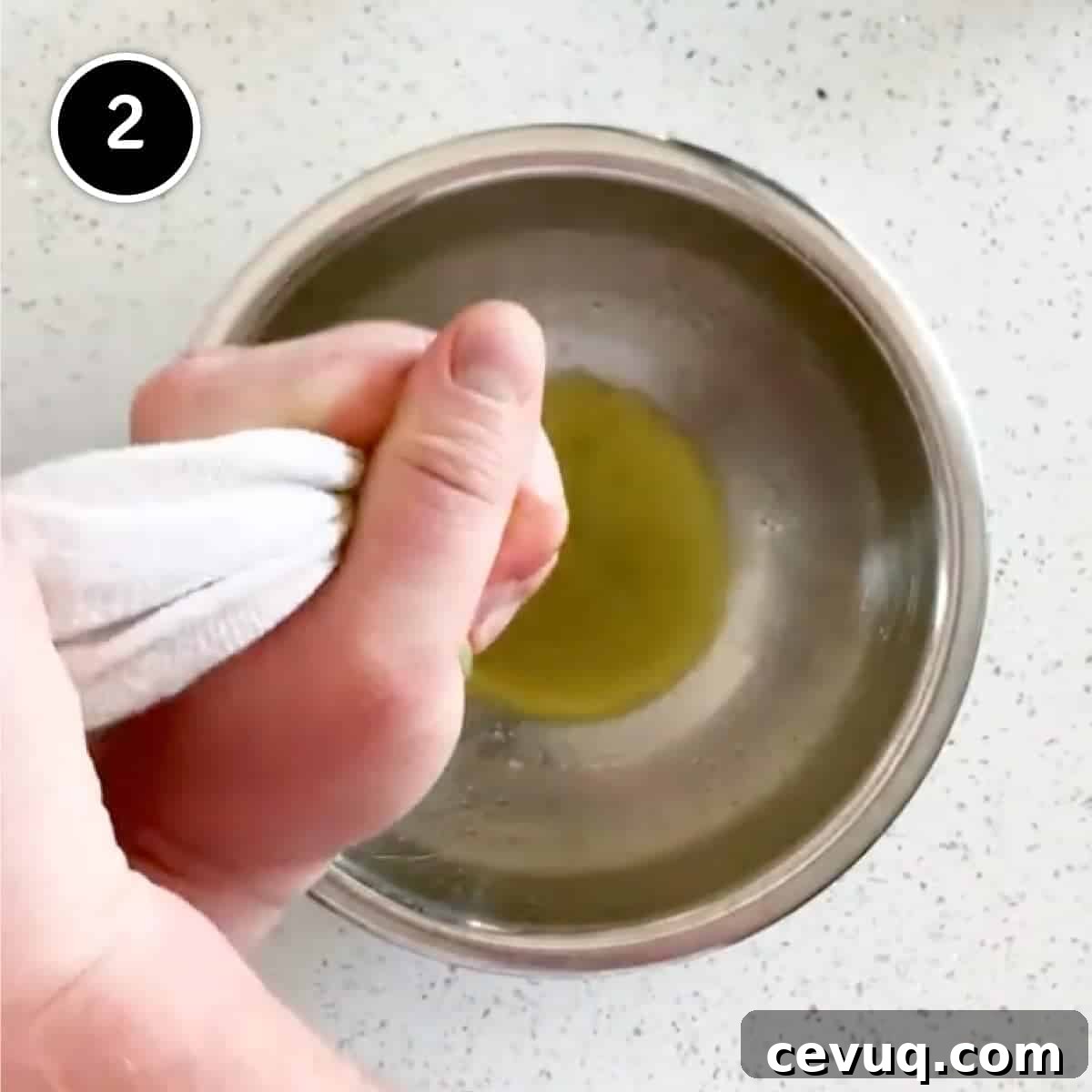 Squeezing out the excess liquid from the cavolo nero cabbage using a tea towel