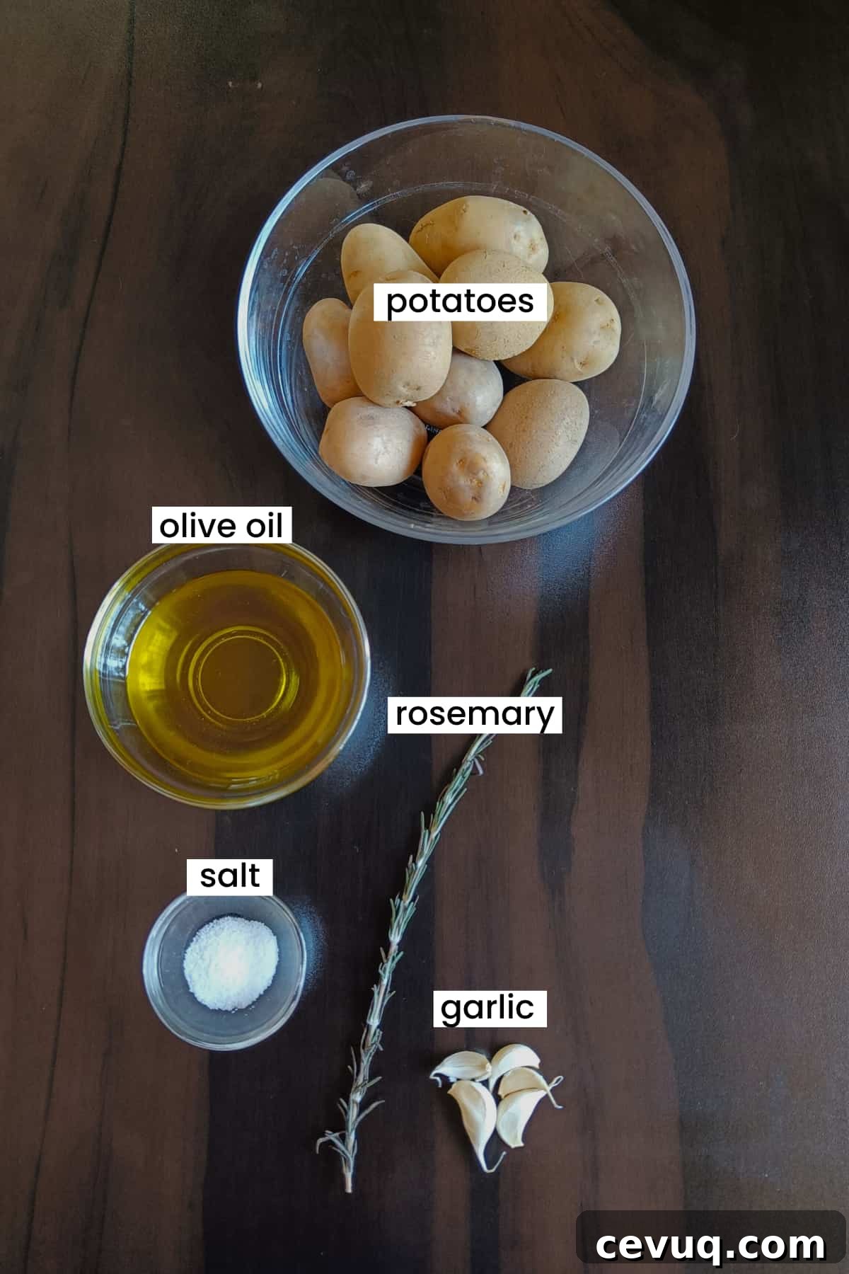 Ingredients are arranged on a brown backdrop for mashed potatoes recipe.