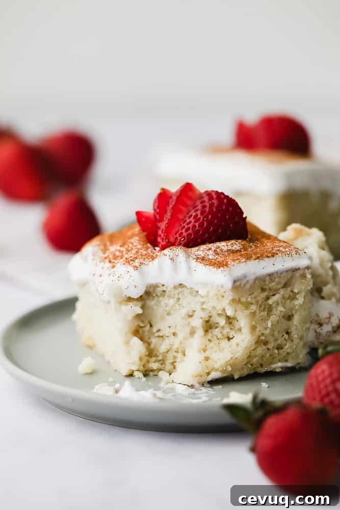 yellow cake with white frosting and strawberries on top