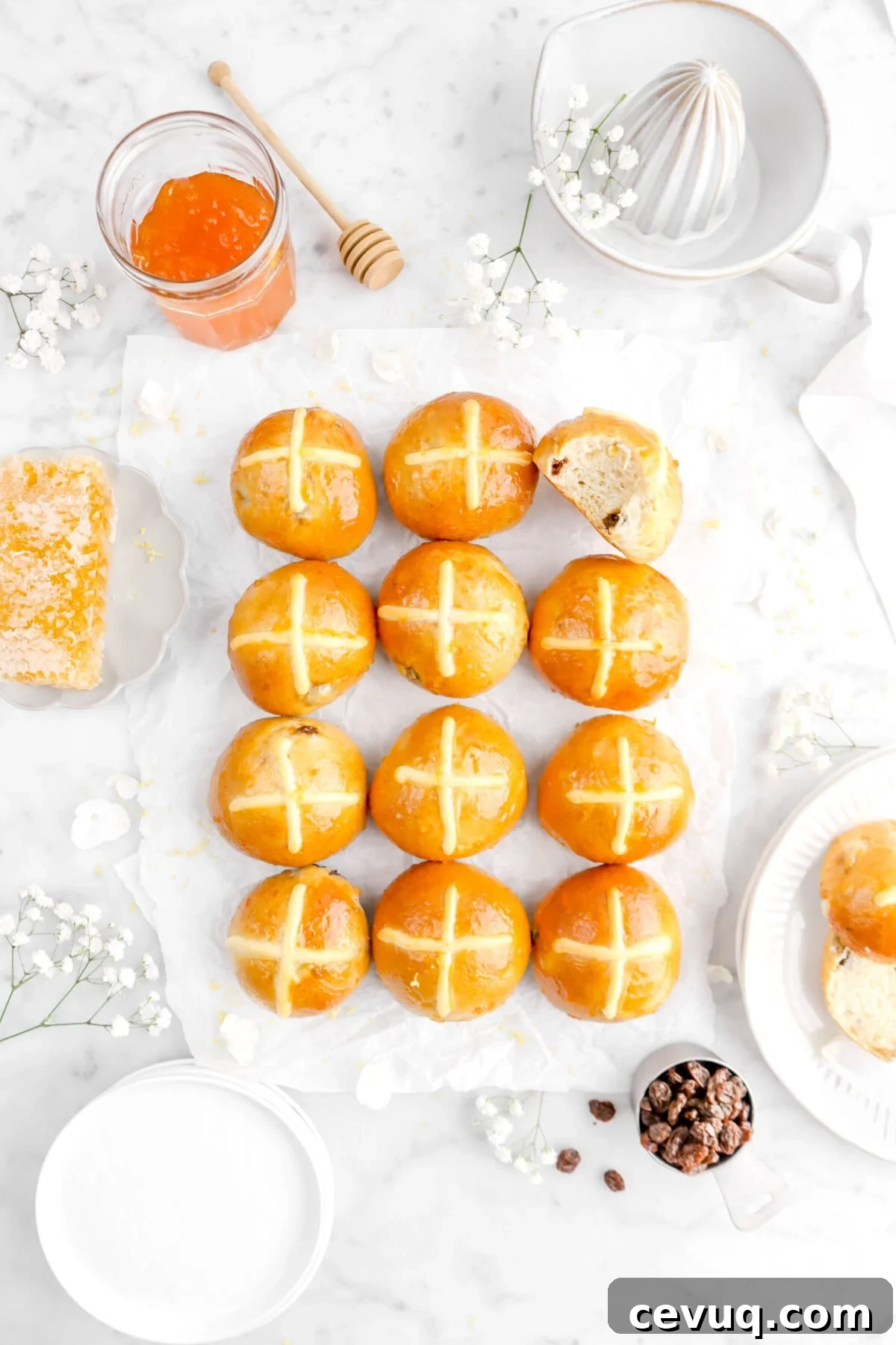 overhead shot of hot cross buns with top right bun missing a bite