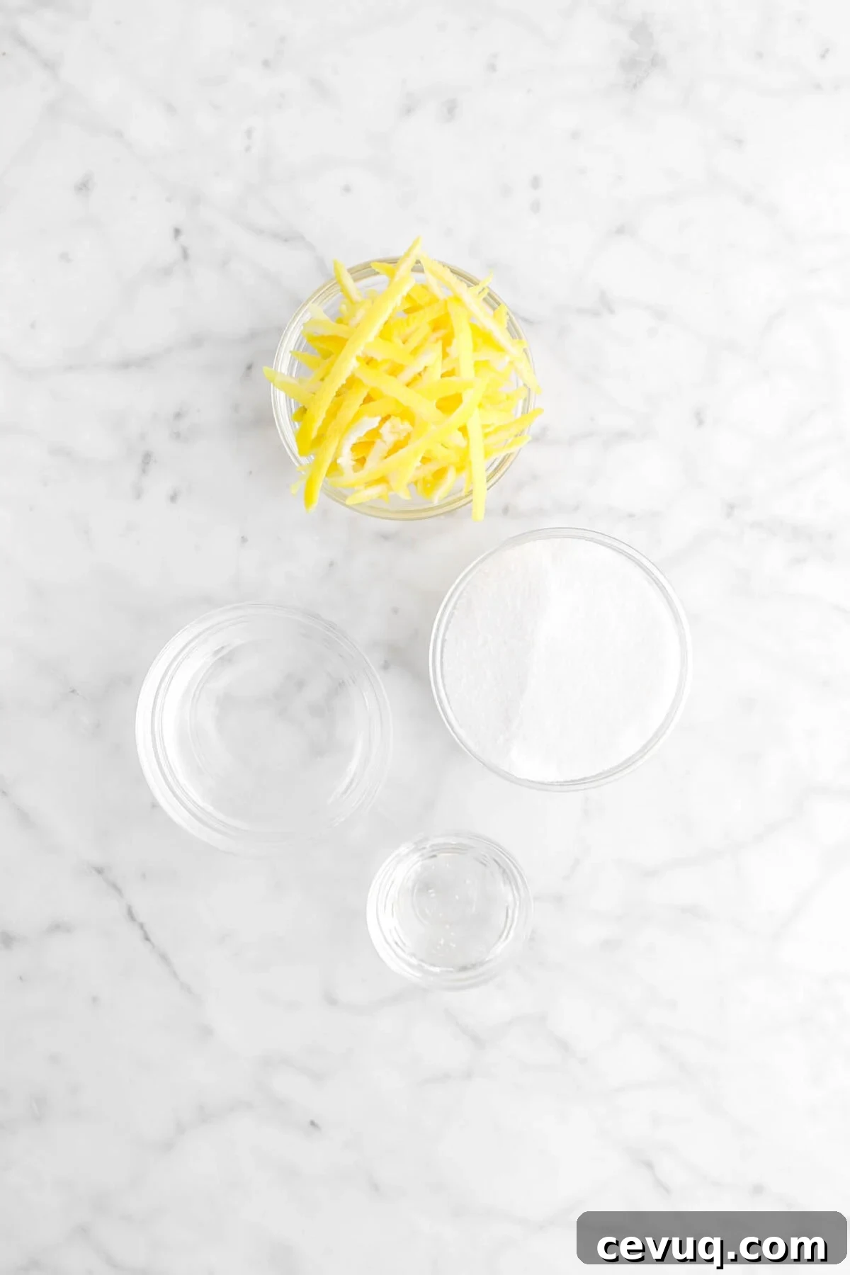 lemon peel, sugar, water, and corn syrup on marble surface
