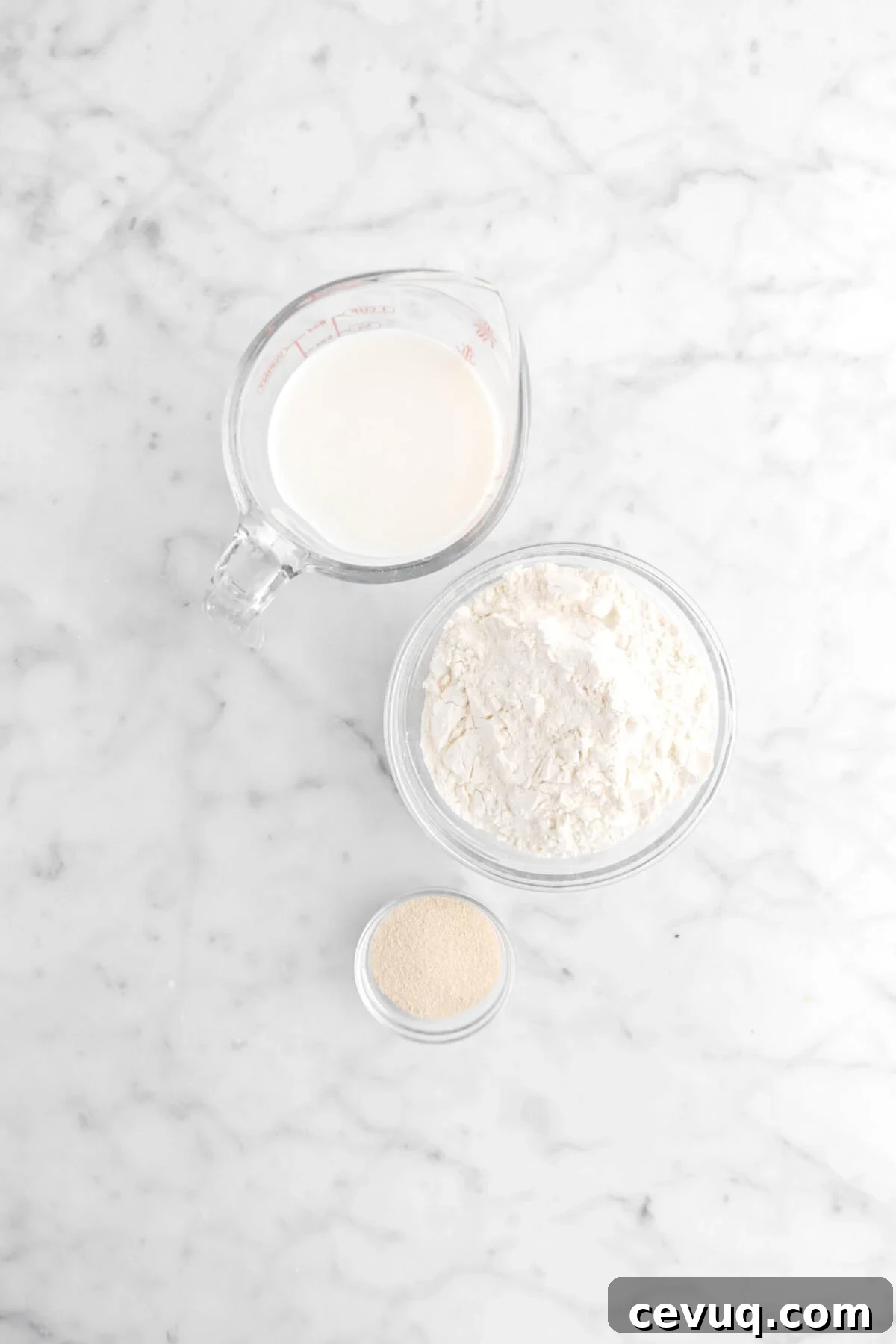 milk, flour, and yeast on marble surface