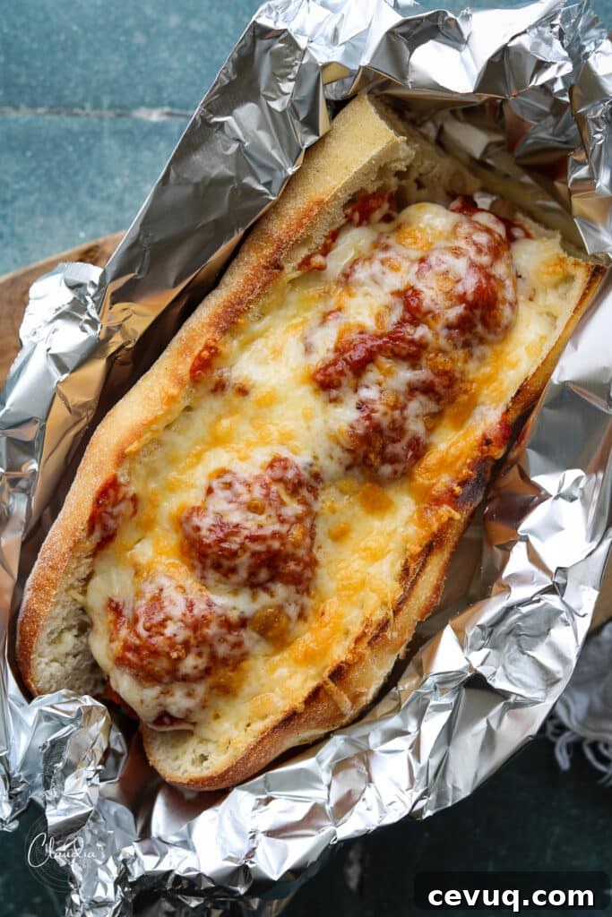 Baked Chicken Pesto Meatball Sub with tons of melted cheese 