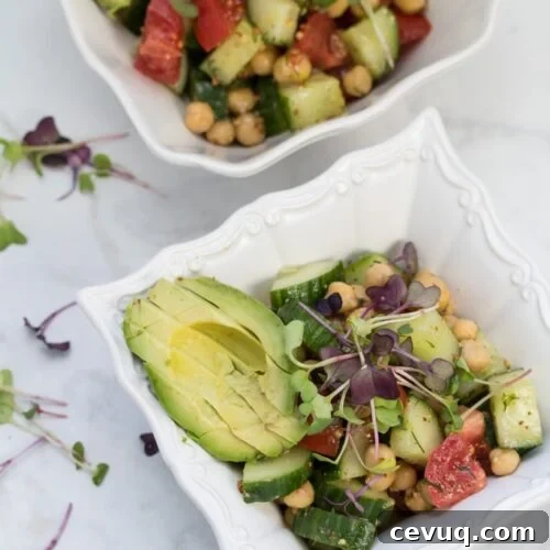Lemon-Dill Chickpea Salad with Fresh Herb Vinaigrette 7 A bowl of chickpea salad with avocado and microgreens.