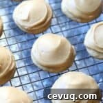 Banana cookies topped with caramel frosting on a wire rack.
