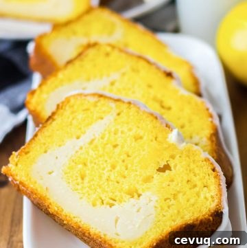 Slices of lemon cheesecake loaf on a white rectangular plate