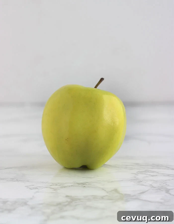yellow golden delicious apple on a white background