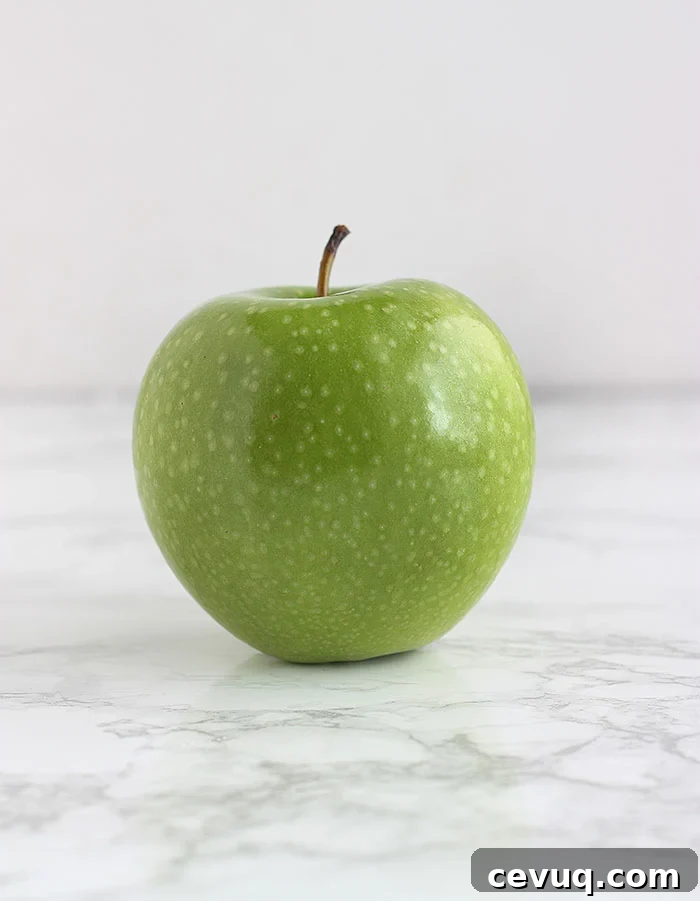 green Granny Smith apple on a white background