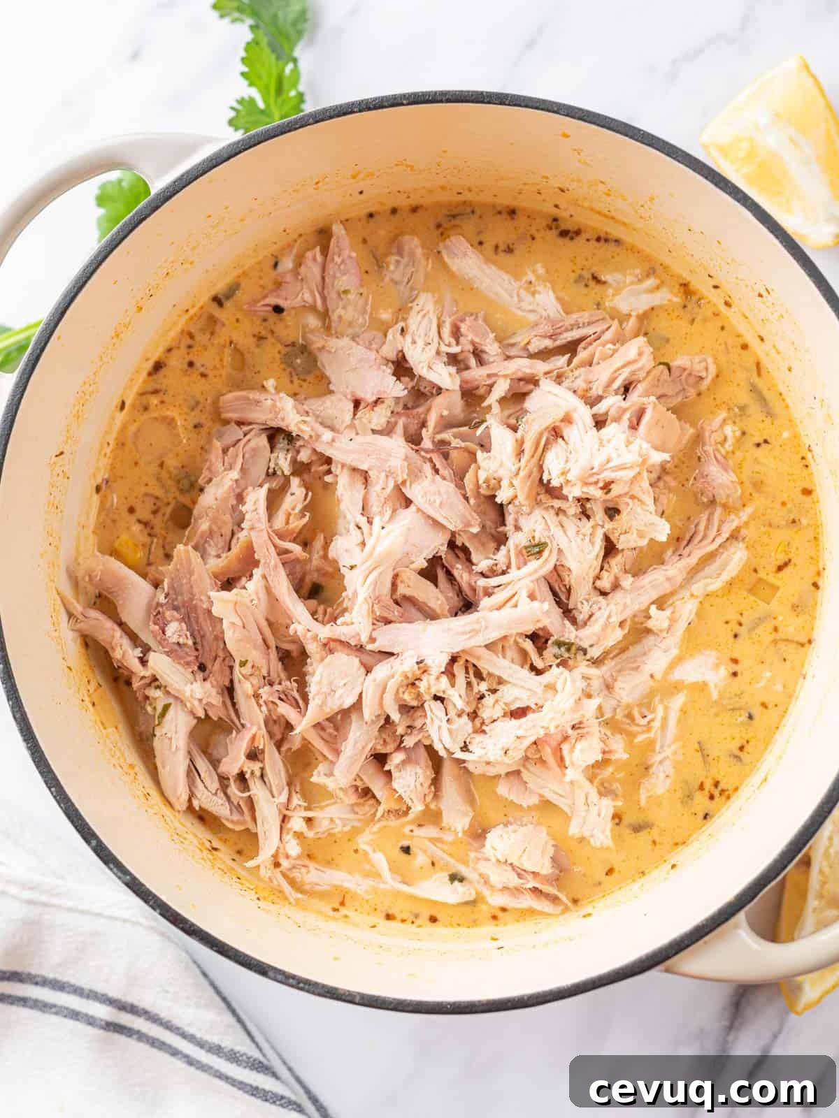 Easy White Chicken Chili Recipe in pot after adding shredded chicken