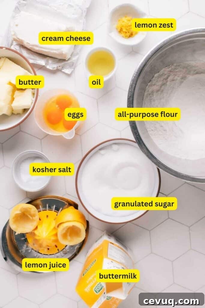Ingredients for Lemon Curd Cake laid out on a kitchen countertop including all-purpose flour, eggs, cream cheese, lemon, butter, oil, sugar, buttermilk, etc.