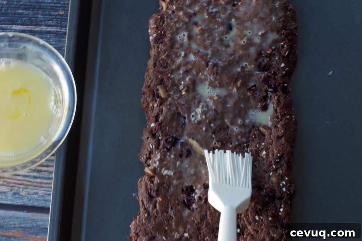Chocolate Zucchini Biscotti Recipe: Crunchy, Moist, and Perfect for Coffee 10 egg wash being brushed onto biscotti loaf