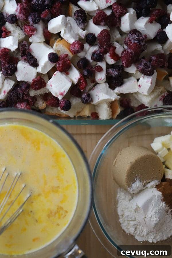 French Toast Casserole with cream cheese and mixed berries in a baking dish.