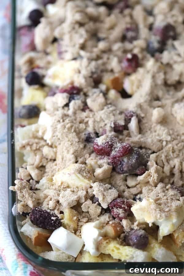 French toast cream cheese casserole in a baking dish reach to bake.