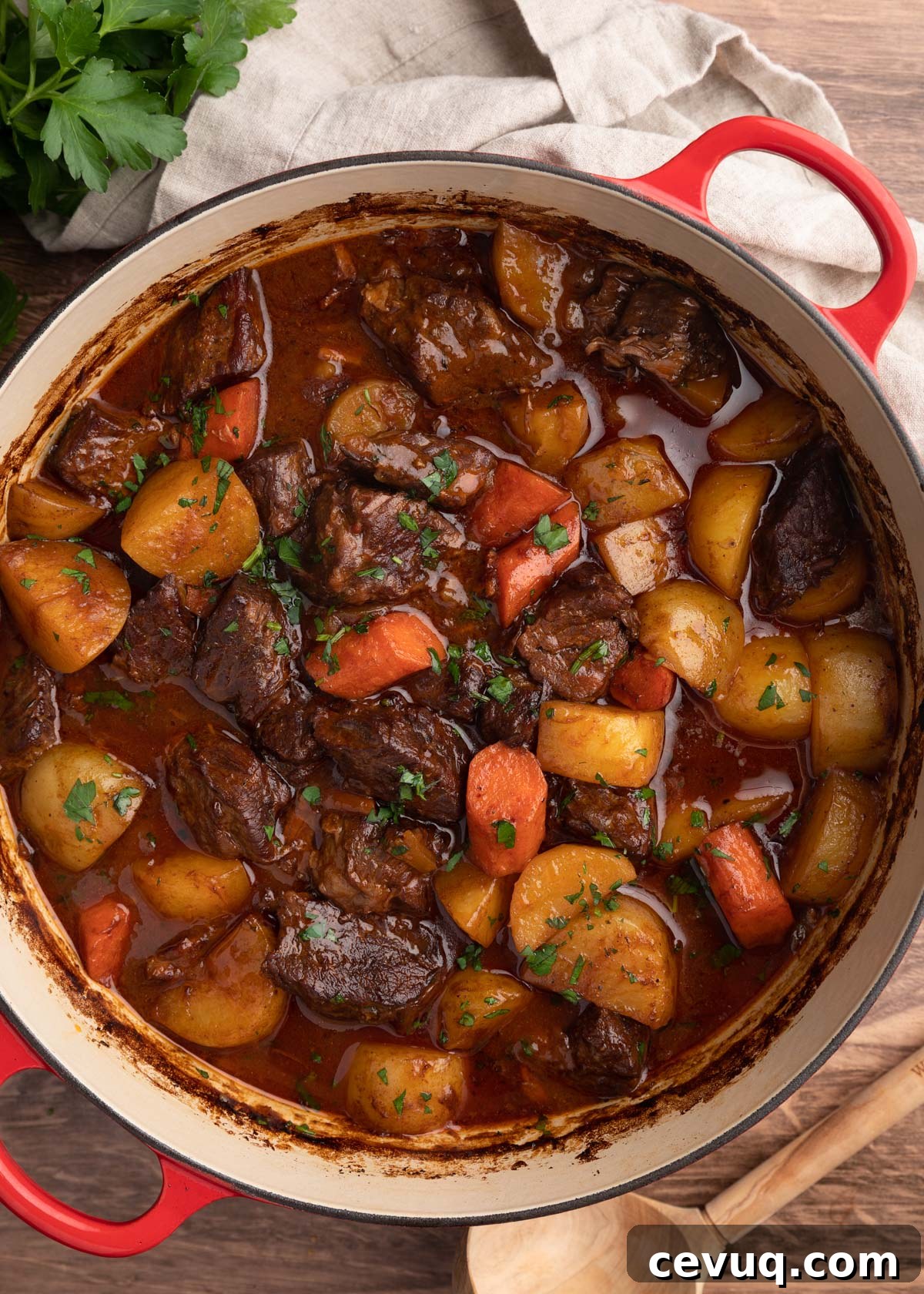 overhead photo of cooked Guinness Beef Stew with potatoes and carrots in a Dutch oven