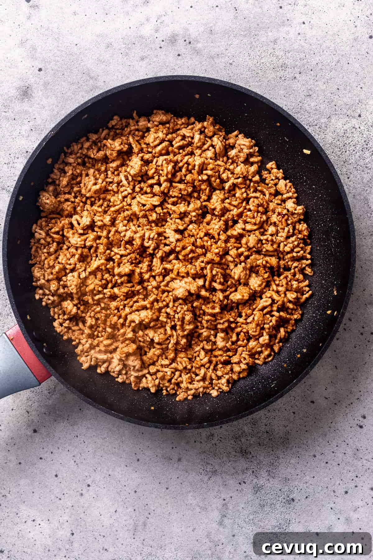 Crispy Homemade Egg Rolls: Step-by-Step Recipe for Perfect Rolls 6 Minced (ground) pork in a skillet for egg roll filling.