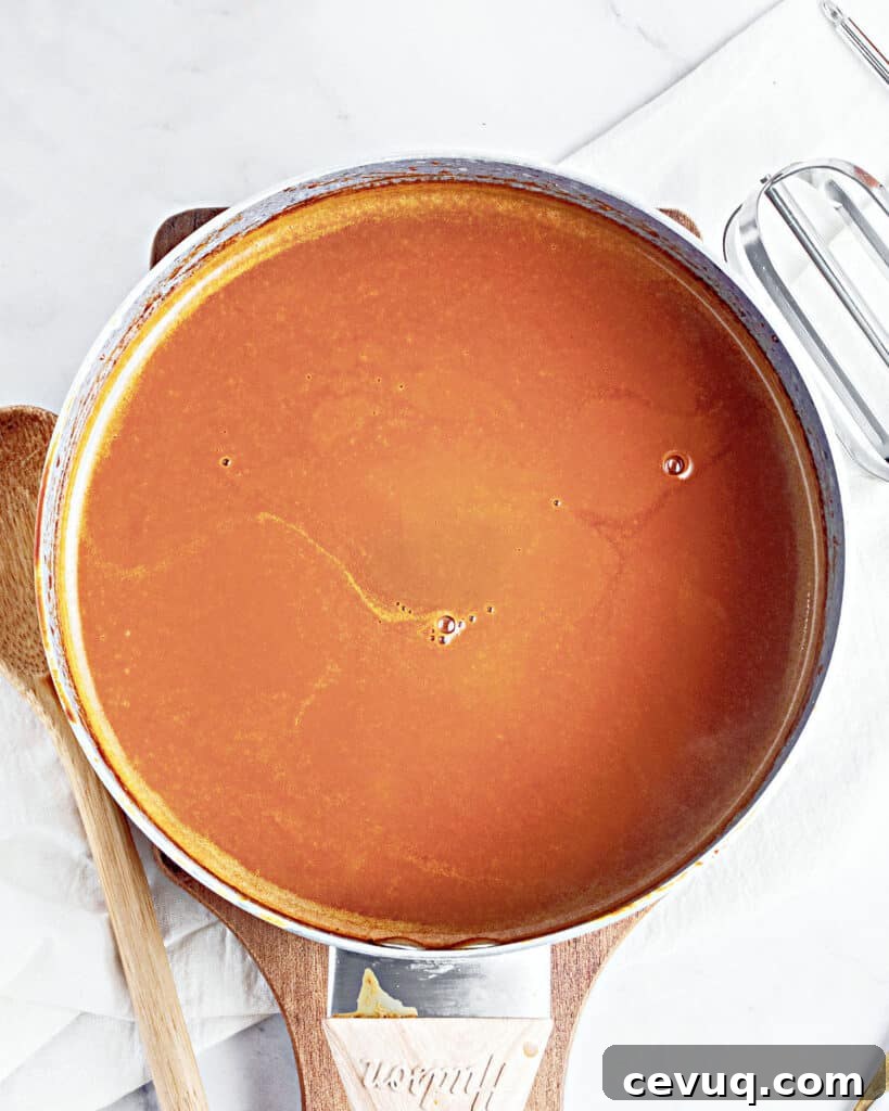 Top view of skillet with caramel cream custard mixture. White gray marbled background.