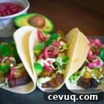 Pork Belly Tacos with Pickled Onion, Roasted Pineapple, and Avocado Lime Sour Cream | Savorwithjennifer.com