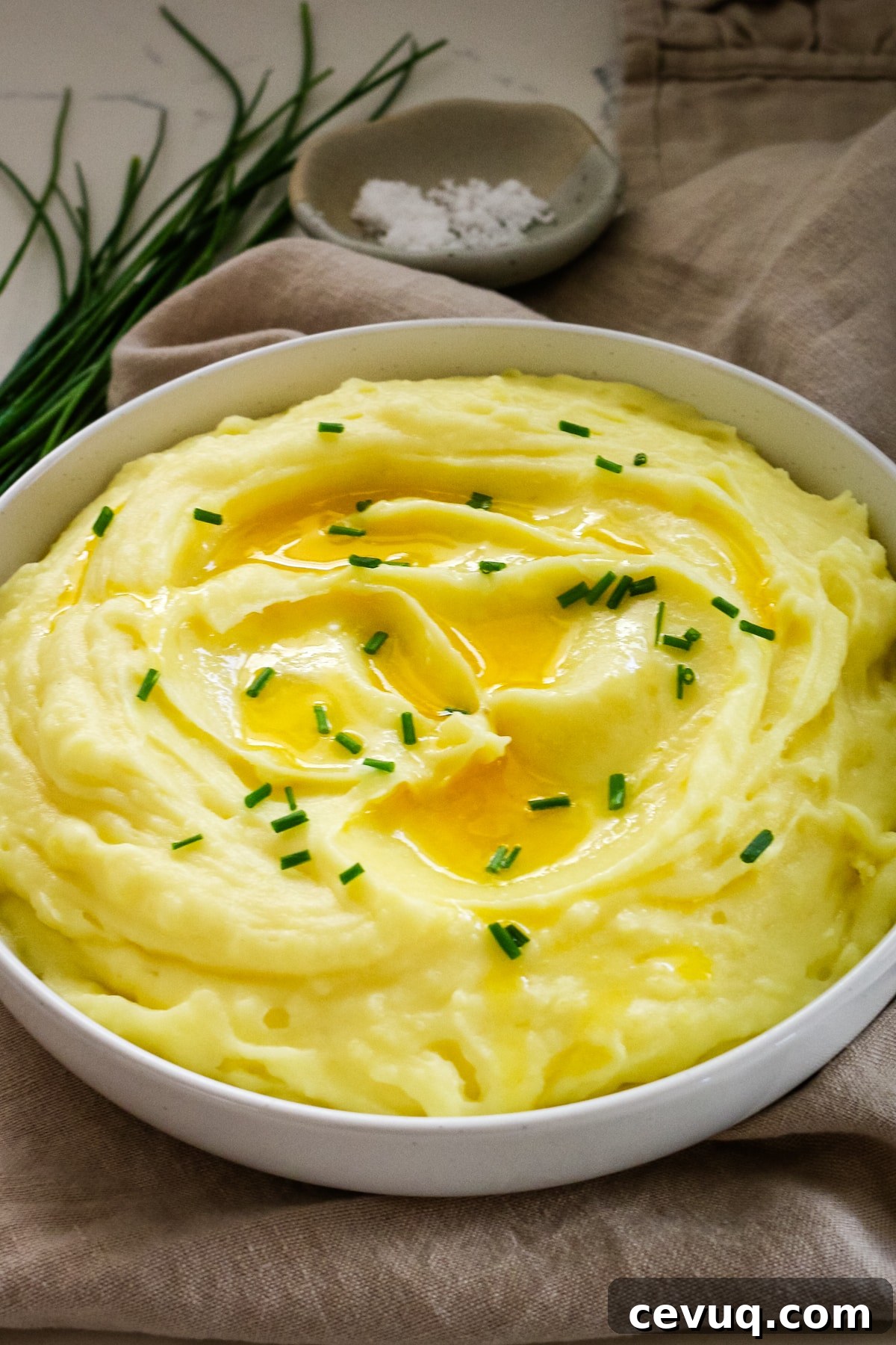 Mashed potatoes in a white bowl.