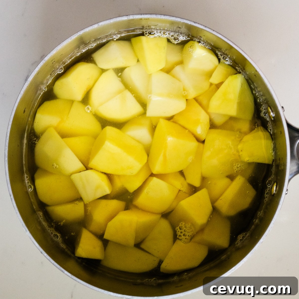 Potatoes in a pan with water.