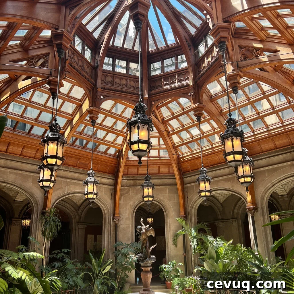 An ornate dome ceiling above an indoor garden and classical architecture.