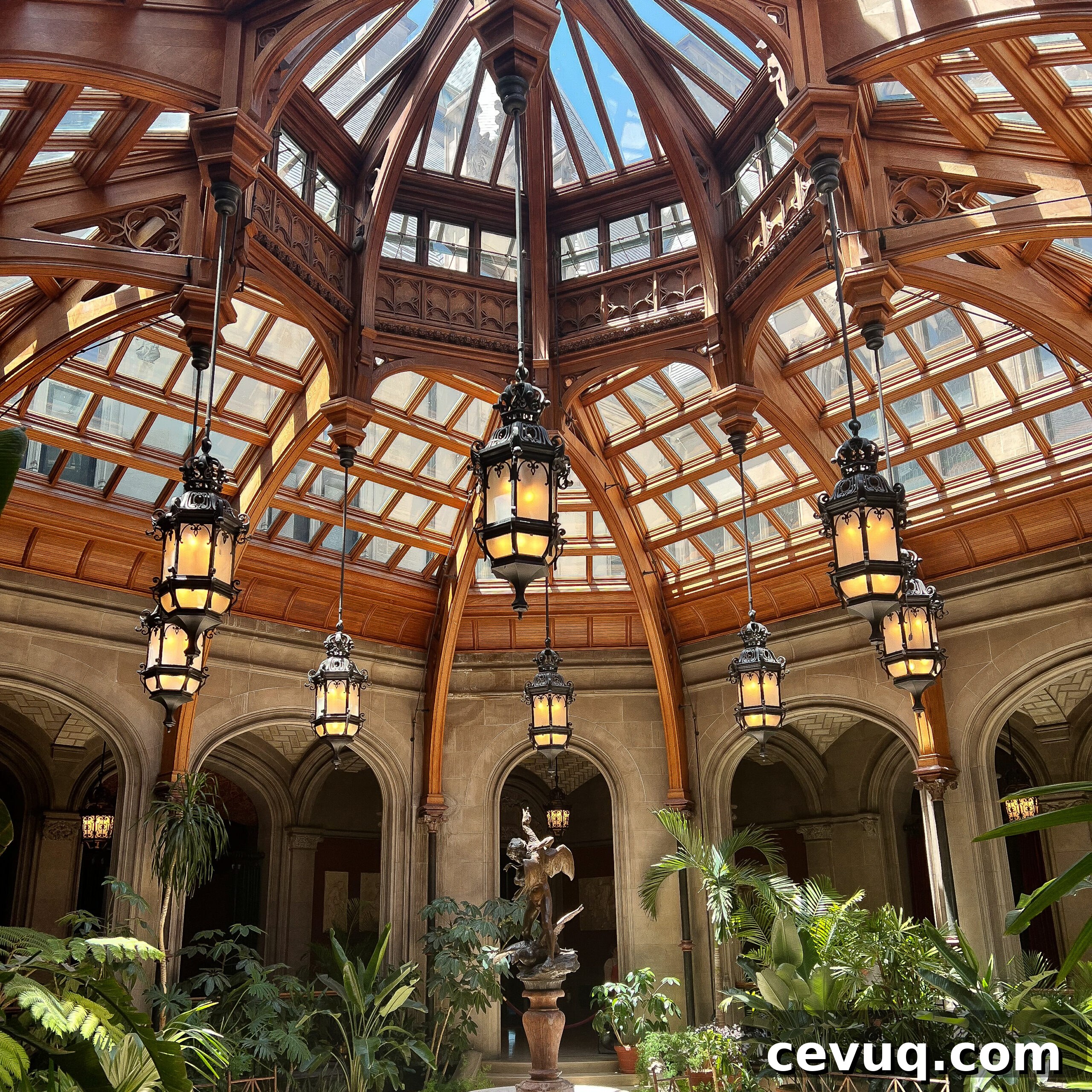 An ornate dome ceiling above an indoor garden and classical architecture.