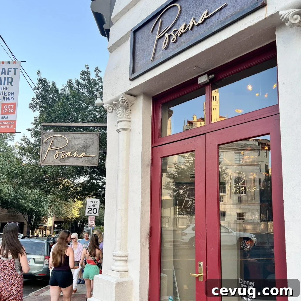 Street view of a restaurant entrance with red-framed glass doors.
