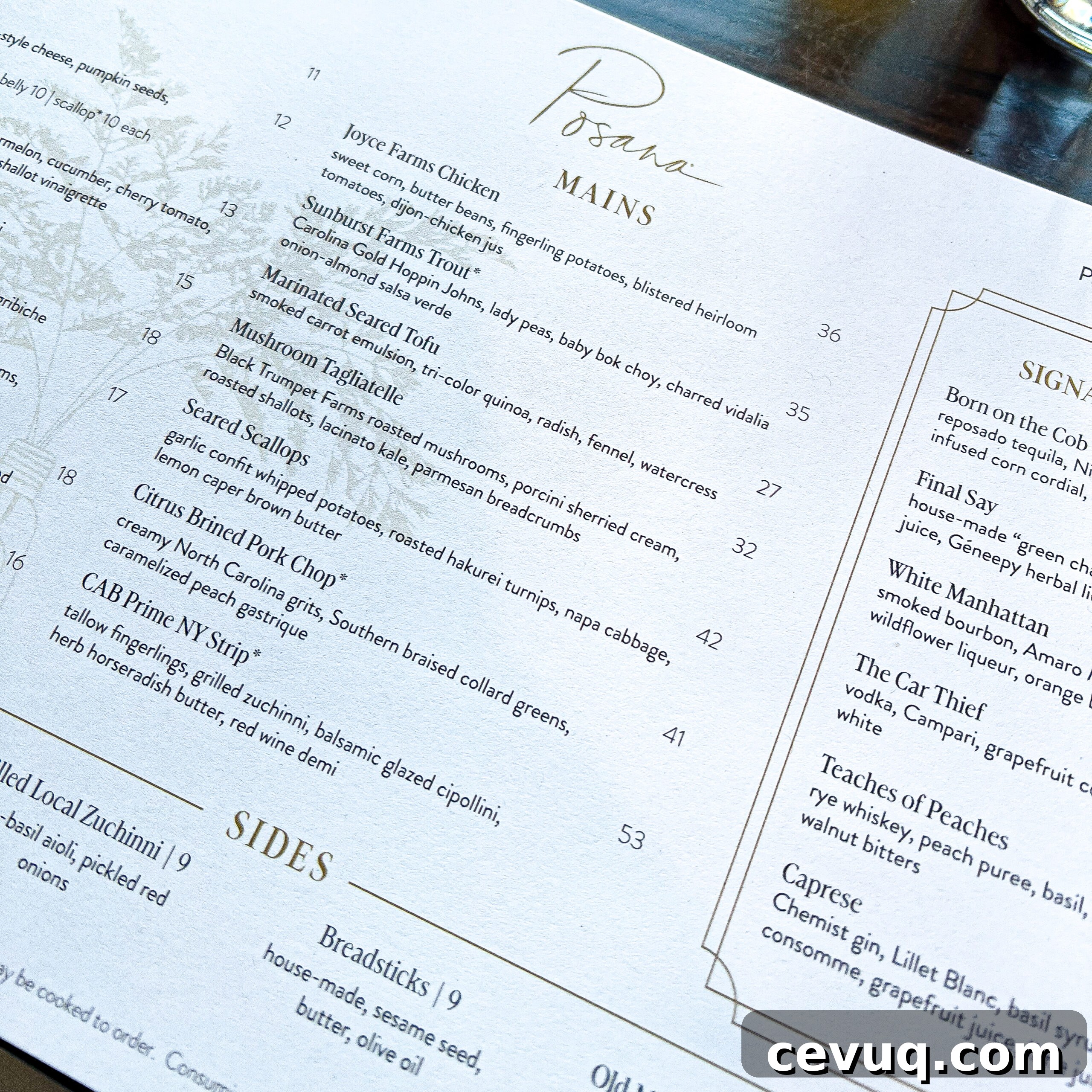 A menu showing mains like chicken, trout, and steak alongside sides and cocktails.