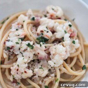 lobster scampi in a white bowl up close.