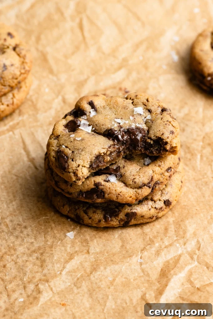 Bakery-Style Chocolate Chip Cookies Recipe for Perfect Texture 13 Stack of three chocolate chip cookies with the top one missing a bite.