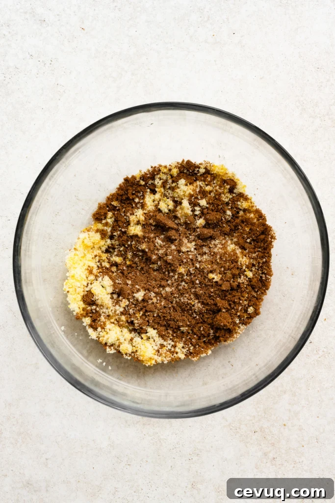 Bakery-Style Chocolate Chip Cookies Recipe for Perfect Texture 5 Overhead view of bowl filled with orange zest, sugar, and brown sugar.