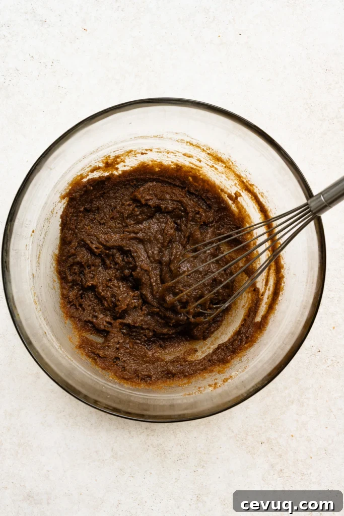Bakery-Style Chocolate Chip Cookies Recipe for Perfect Texture 6 Melted butter and brown sugar whisked together in a mixing bowl.