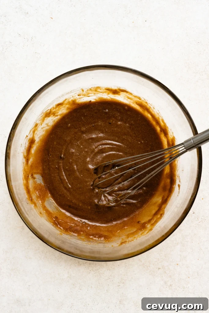 Bakery-Style Chocolate Chip Cookies Recipe for Perfect Texture 7 Brown sugar, melted butter, and eggs whisked together in a mixing bowl.