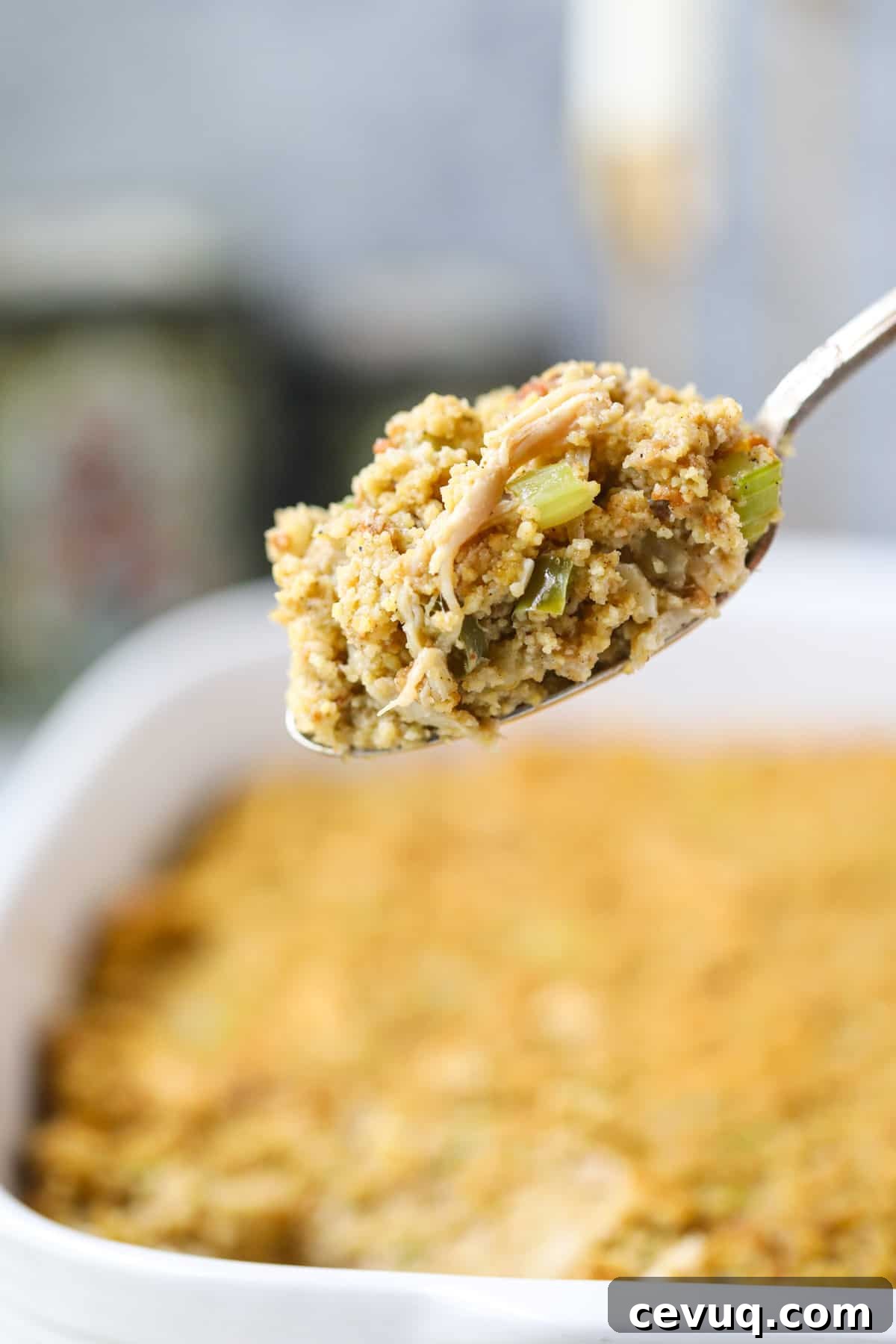 Southern chicken and dressing on a serving spoon to show texture.
