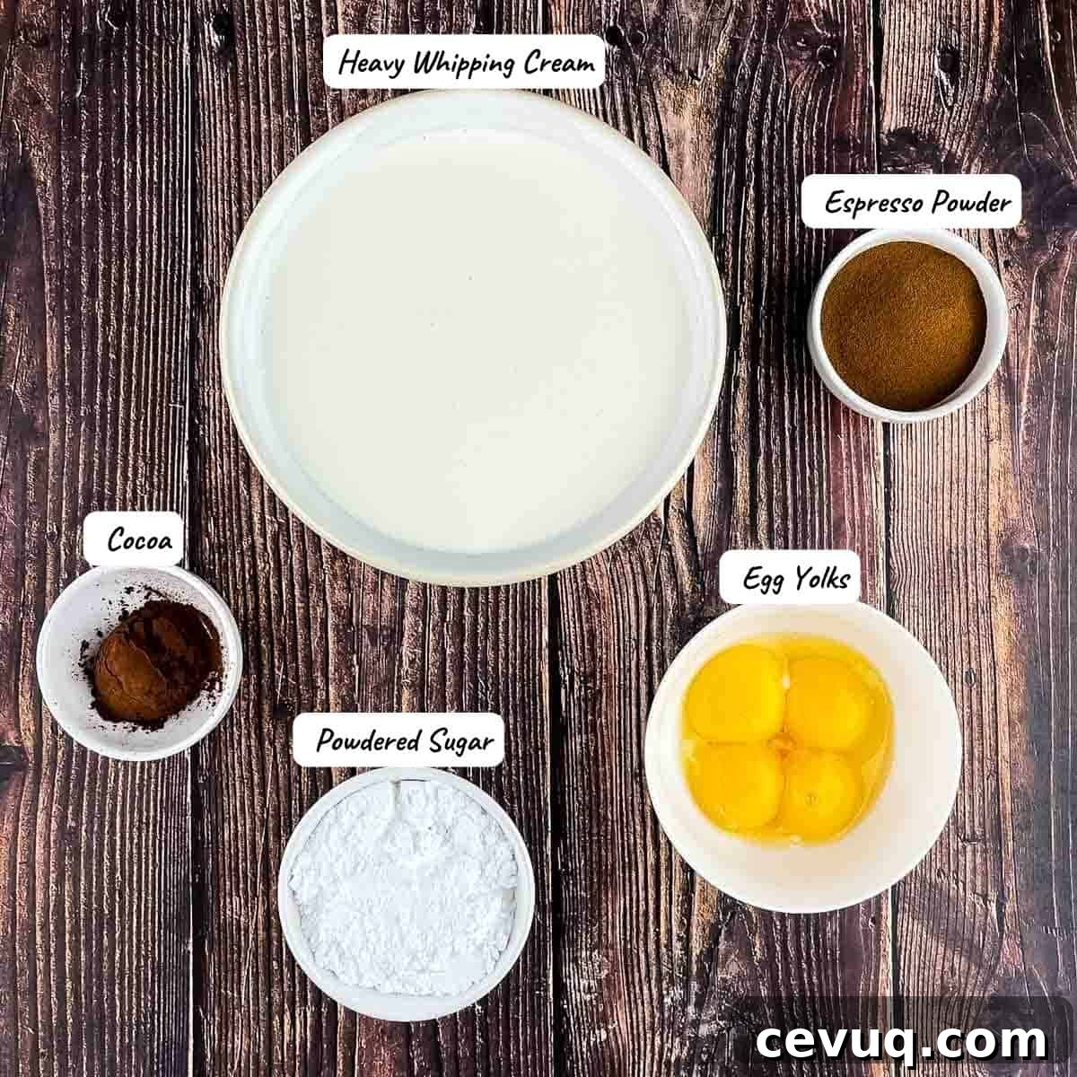 The ingredients for coffee mousse measured out and placed on a wooden table.