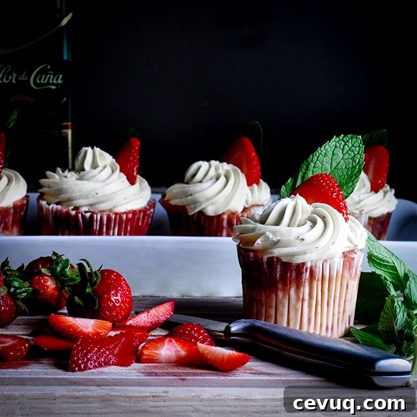 Strawberry mojito cupcakes with Italian Meringue Buttercream and fresh cut strawberries.