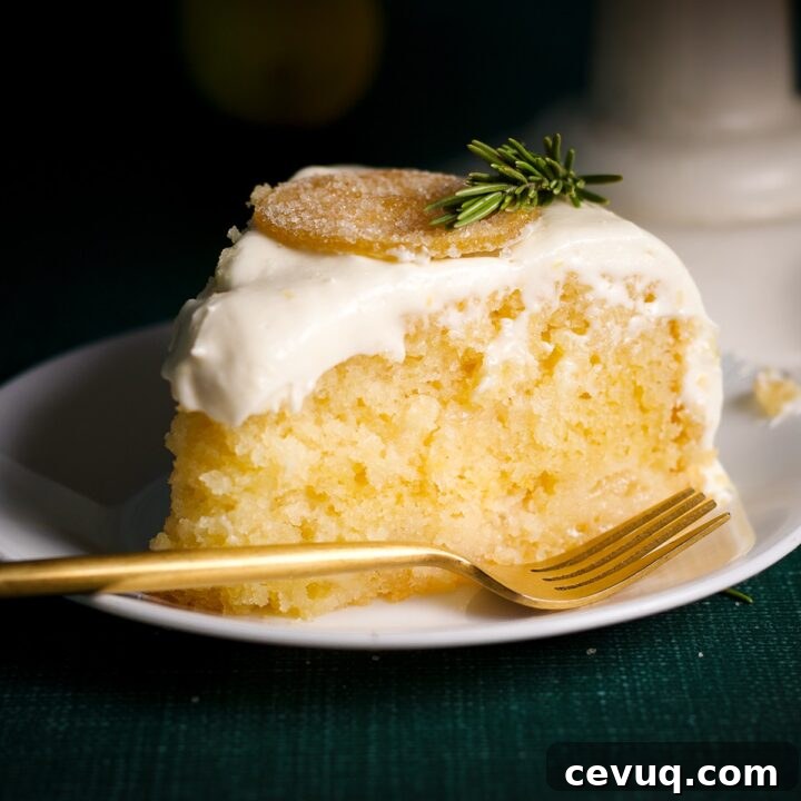 A slice of elderflower lemon cake on plate with a fork.