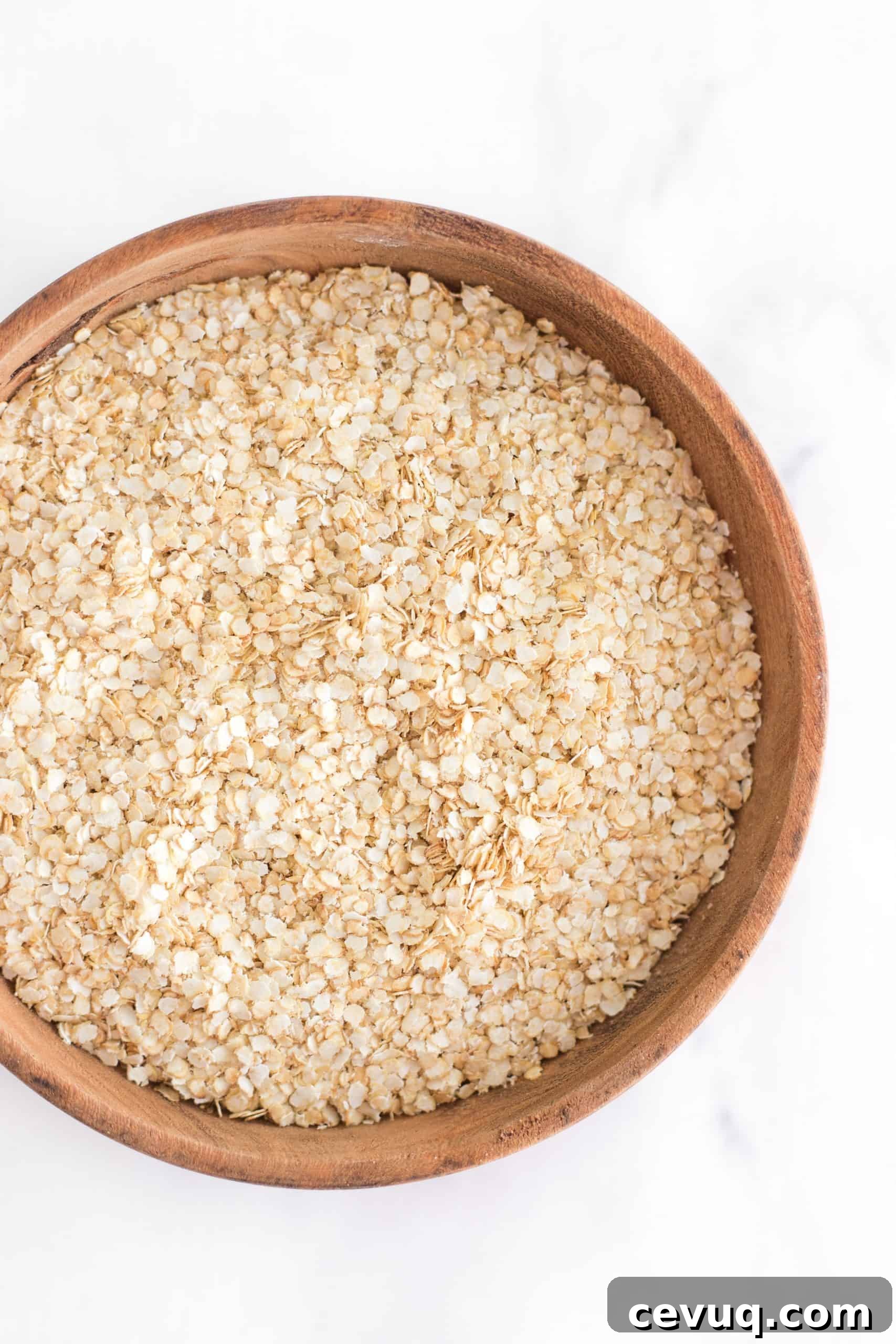 How to Cook Quinoa Flakes Quinoa flakes in a wooden bowl.