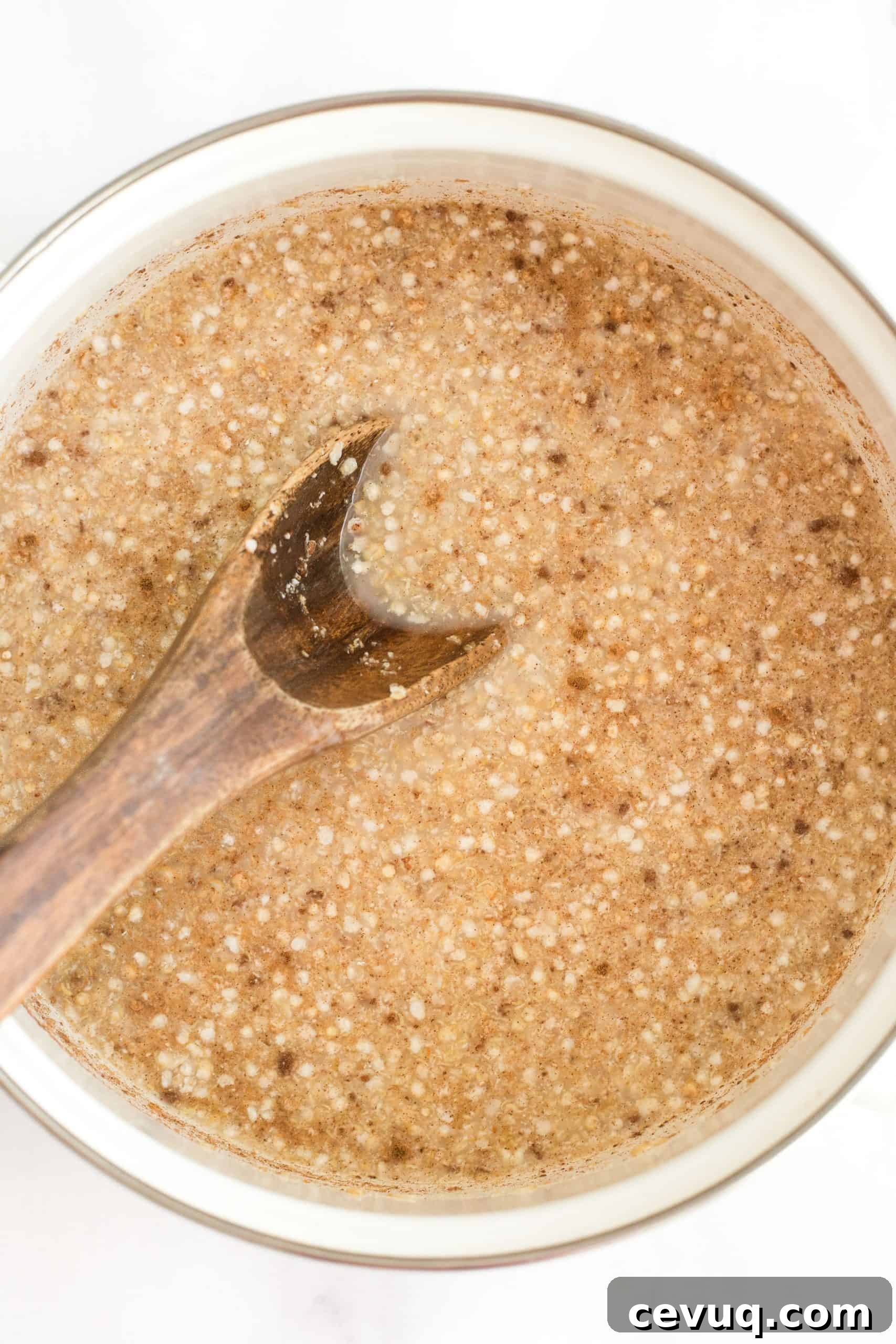 5-Minute Creamy Quinoa Porridge (Gluten-Free, Vegan) Mixing wet ingredients in a white pot.