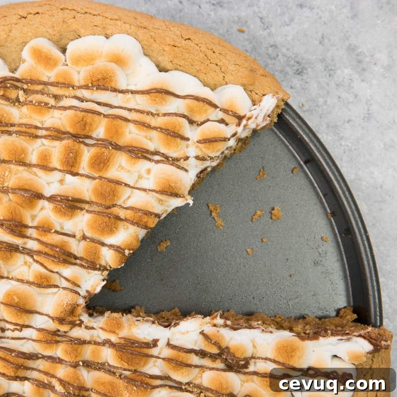 S'mores Dessert Pizza Recipe: Gooey Chocolate and Marshmallow Pie 3 This photo shows Smores Pizza in a pizza pan after a piece has been served