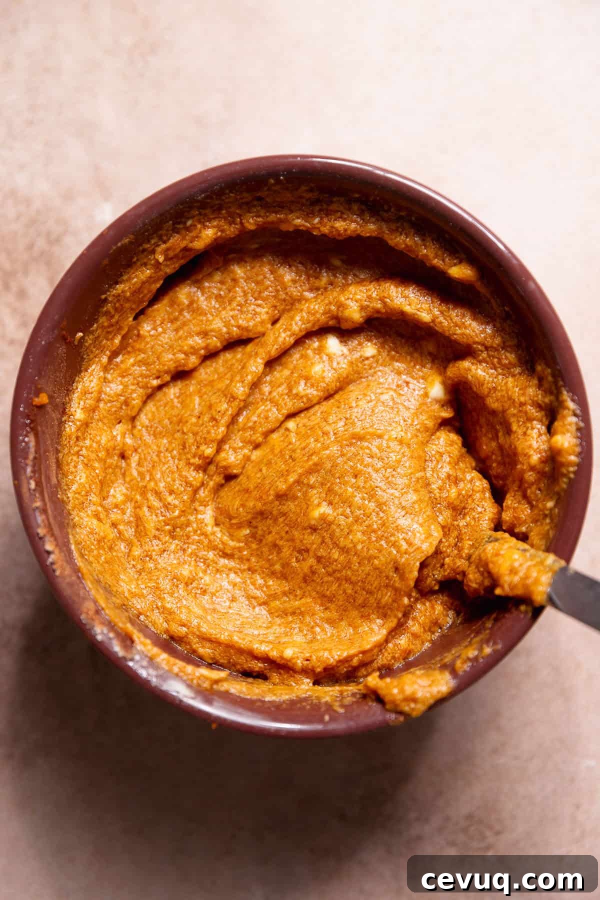 Pumpkin Cinnamon Rolls with Cream Cheese Cinnamon Frosting 5 Brown sugar pumpkin pie filling for the cinnamon rolls in a purple bowl.