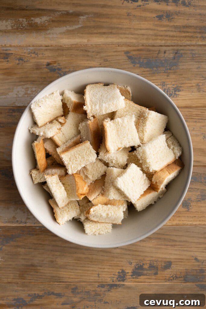 Cubing stale bread to make bread pudding.
