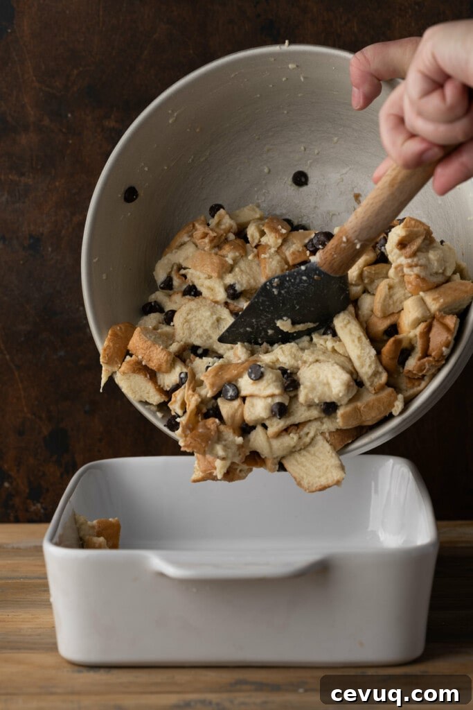 Transferring Bread Pudding with Chocolate Chips to baking dish to bake in the oven.
